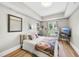 Bright bedroom with wood floors and a comfortable bed at 222 Glenwood Ave # 307, Raleigh, NC 27603