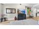 Living room with hardwood floors, large TV, and eclectic artwork at 222 Glenwood Ave # 307, Raleigh, NC 27603