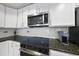 Modern kitchen with granite countertops and stainless steel appliances at 222 Glenwood Ave # 307, Raleigh, NC 27603