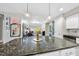 Kitchen island with granite countertop and seating for three at 222 Glenwood Ave # 307, Raleigh, NC 27603