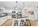 Open concept kitchen with granite island, stainless steel appliances, and white cabinets at 222 Glenwood Ave # 307, Raleigh, NC 27603