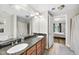Double vanity bathroom with granite countertops and a shower/tub combo at 222 Glenwood Ave # 307, Raleigh, NC 27603