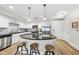 Open concept kitchen with granite island, stainless steel appliances, and white cabinets at 222 Glenwood Ave # 307, Raleigh, NC 27603