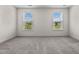 Well-lit bedroom with carpeted floor and large windows at 135 Glenfield Ln, Burlington, NC 27215