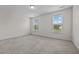 Bright bedroom with carpeted floor and two windows at 135 Glenfield Ln, Burlington, NC 27215