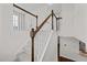 Indoor staircase with wooden railing and carpeted steps at 135 Glenfield Ln, Burlington, NC 27215