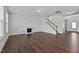 Bright living room with hardwood floors, fireplace, and stairs at 135 Glenfield Ln, Burlington, NC 27215