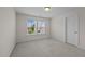 Well-lit bedroom featuring carpet and a large window at 135 Glenfield Ln, Burlington, NC 27215
