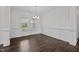 Spacious dining room with hardwood floors, wainscoting, and a chandelier at 135 Glenfield Ln, Burlington, NC 27215