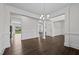 Open dining room with hardwood floors, wainscoting, and view into kitchen at 135 Glenfield Ln, Burlington, NC 27215