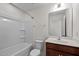 Bathroom with tub, toilet and brown vanity at 135 Glenfield Ln, Burlington, NC 27215