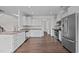 Modern kitchen with white cabinets, granite countertops, and stainless steel appliances at 135 Glenfield Ln, Burlington, NC 27215