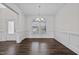Bright dining room with hardwood floors, wainscoting, and chandelier, view of entryway at 135 Glenfield Ln, Burlington, NC 27215