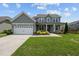 Two-story house with gray siding, two-car garage, and landscaping at 135 Glenfield Ln, Burlington, NC 27215