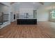 Open concept kitchen with island, white cabinets, and stainless steel appliances at 16 Autumn Breeze Ct, Angier, NC 27501