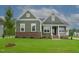 Front view of charming two-story home with green siding at 16 Autumn Breeze Ct, Angier, NC 27501