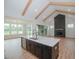 Spacious Gathering room with high ceilings, exposed beams, and a modern fireplace at 16 Autumn Breeze Ct, Angier, NC 27501