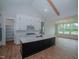Modern kitchen featuring white cabinets, a large island, and a walk-in pantry at 16 Autumn Breeze Ct, Angier, NC 27501