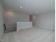 Open loft area with carpeted floors and staircase at 16 Autumn Breeze Ct, Angier, NC 27501