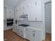 White cabinets, gas cooktop and built-in oven highlighted in this kitchen at 16 Autumn Breeze Ct, Angier, NC 27501
