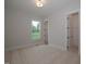Bright bedroom with carpeted floor, large window, and access to a private bathroom and closet at 16 Autumn Breeze Ct, Angier, NC 27501