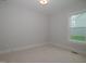 Spacious bedroom with carpeted floor and a window offering natural light at 16 Autumn Breeze Ct, Angier, NC 27501