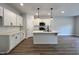 Modern kitchen with white cabinets and island at 156 S Mistflower St, Clayton, NC 27520