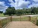Wooden deck overlooking a grassy yard with trees at 156 S Mistflower St, Clayton, NC 27520