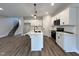 Modern kitchen with white cabinets and island at 156 S Mistflower St, Clayton, NC 27520