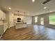Open living room with hardwood floors and access to patio at 156 S Mistflower St, Clayton, NC 27520
