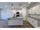 Modern kitchen with white cabinets, granite countertops, and island at 152 S Mistflower St, Clayton, NC 27520