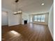 Spacious living room with hardwood floors, fireplace and large windows at 1220 Porters Call Dr, Wendell, NC 27591