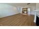 Open living room with hardwood floors and kitchen view at 1220 Porters Call Dr, Wendell, NC 27591