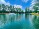 Peaceful community lake with a central fountain at 1220 Porters Call Dr, Wendell, NC 27591