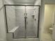 Large walk-in shower with built-in seat and marble tile at 1220 Porters Call Dr, Wendell, NC 27591