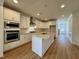 Modern kitchen with white cabinets and granite island at 1220 Porters Call Dr, Wendell, NC 27591