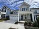 Two story home with gray siding and teal front door at 1220 Porters Call Dr, Wendell, NC 27591