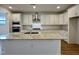 Modern kitchen with white cabinets and granite island at 1220 Porters Call Dr, Wendell, NC 27591