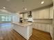 Modern kitchen with white cabinets and granite island at 1220 Porters Call Dr, Wendell, NC 27591