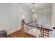 Upper hallway with hardwood floors and staircase at 308 College St, Oxford, NC 27565