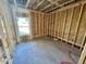 Unfinished bedroom with window and exposed framing at 81 Eagle Crest Ct # Apex Craftsman, Lillington, NC 27546