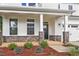Covered front porch with stone columns and a dark-colored front door at 81 Eagle Crest Ct # Apex Craftsman, Lillington, NC 27546