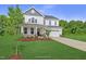 Two-story white house with gray roof, stone accents, and a two-car garage at 81 Eagle Crest Ct # Apex Craftsman, Lillington, NC 27546