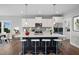 Modern kitchen with a large island, white cabinets, and stainless steel appliances at 81 Eagle Crest Ct # Apex Craftsman, Lillington, NC 27546