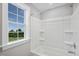 Clean bathroom with a shower/tub combo and large window at 81 Eagle Crest Ct # Apex Craftsman, Lillington, NC 27546