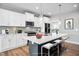 Bright kitchen features white cabinets, a large island, and stainless steel appliances at 81 Eagle Crest Ct # Apex Craftsman, Lillington, NC 27546