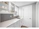 Well-equipped butler's pantry with white cabinets and gray tile backsplash at 81 Eagle Crest Ct # Apex Craftsman, Lillington, NC 27546
