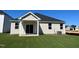 House exterior showcasing a beige-toned siding, covered patio and green lawn at 150 Chestnut Oak Ln, Lillington, NC 27546