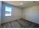 Well-lit bedroom with carpet flooring and a large window at 150 Chestnut Oak Ln, Lillington, NC 27546