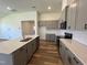 Modern kitchen with gray cabinets, quartz countertops and island at 150 Chestnut Oak Ln, Lillington, NC 27546